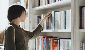 Woman choosing books in bookstore